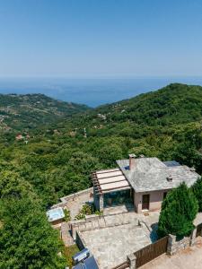 an aerial view of a house on a hill at A Dream Deferred villa Pelion in Kissos