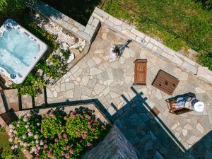 an overhead view of a patio with a pool and flowers at A Dream Deferred villa Pelion in Kissos