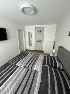 a bedroom with a large bed and a couch at Ferienwohnung zum Kriegerdenkmal in Alzey