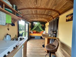 a kitchen and living room in a tiny house at Down under in France in Lormes