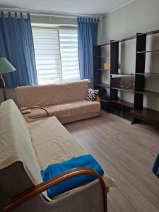 a living room with a couch and a table and a couch at Apartamenty Iława in Iława