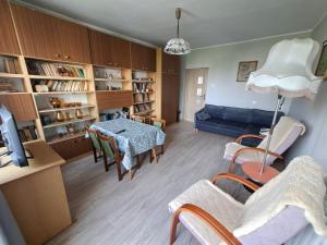 a living room with a blue couch and a table at Apartamenty Iława in Iława