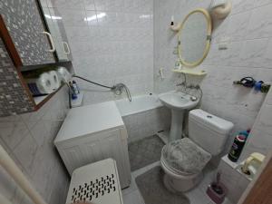 a bathroom with a sink and a toilet and a mirror at Apartamenty Iława in Iława