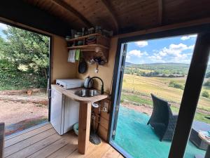 a kitchen with a sink and a sliding glass door at Down under in France in Lormes