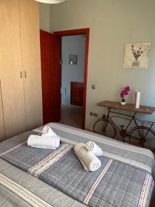 a bedroom with a bed with two towels on it at Thetis I in Alexandroupoli +5 photos