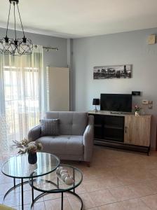 a living room with a couch and a tv at Thetis I in Alexandroupoli