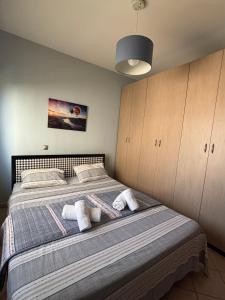 a bedroom with a bed with towels on it at Thetis I in Alexandroupoli