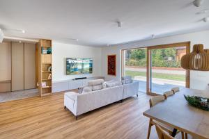 a living room with a couch and a table at Bohinj Rentals Twin Villas in Bohinj