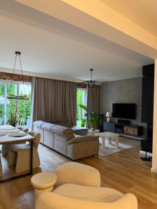 a living room with a couch and a table at Dom nad jeziorem in Ostróda