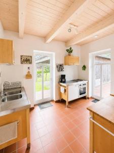 a kitchen with a sink and a stove at Ferienhaus an der Lohheide in Walsrode