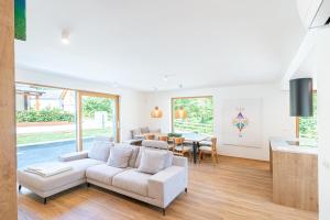 a living room with a couch and a table at Bohinj Rentals Twin Villas in Bohinj