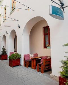 a patio with chairs and a table in a building at Apartment AFRODITA Trnava - Historic centre in Trnava