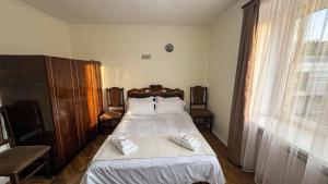 a bedroom with a bed with two towels on it at Sisian Sun House in Sisian