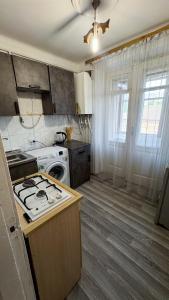a kitchen with a stove and a stove top oven at Sisian Sun House in Sisian