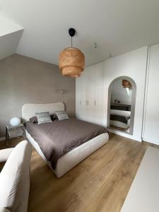 a bedroom with a large bed and a mirror at Dom nad jeziorem in Ostróda