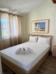a bedroom with a bed with two stuffed animals on it at Sonia in Leptokarya