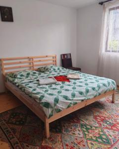 a bed with a quilt on it in a bedroom at Vila close to Bran Castle in Moieciu de Jos