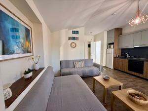 a living room with a couch and a kitchen at Sonia in Leptokarya