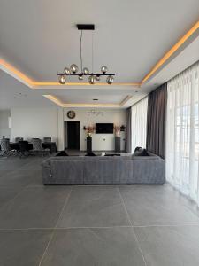 a large living room with a couch and a television at Boa Vista villa in Paramaribo