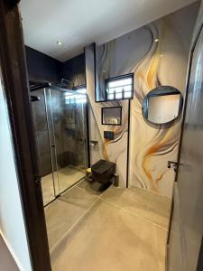 a bathroom with a toilet and a shower at Boa Vista villa in Paramaribo +18 photos