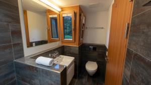a bathroom with a sink and a toilet at PlanB Stay in Silvaplana