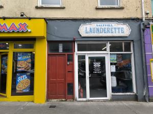 a store front of a pizzeria with a sign on it at Salthill Gem in Galway