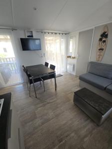 a living room with a couch and a table at O'ContisParadise 2 in Saint-Julien-en-Born