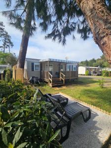 a tiny house with a picnic table in the yard at O'ContisParadise 2 in Saint-Julien-en-Born