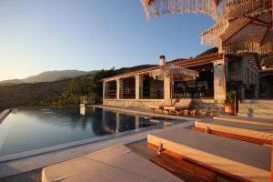a house with a swimming pool and a building at Villa ACROPOLIS in Jal