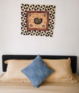 a picture hanging above a bed with two pillows at Nadi Airport Bed & Breakfast in Nadi +9 photos