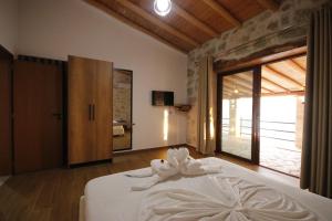 a bedroom with a white bed and a large window at Villa ACROPOLIS in Jal +159 photos