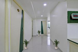 a hallway with potted plants in a building at Hotel O Sunshine Inn in Nagpur