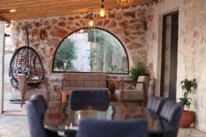 a living room with a couch and chairs and a window at Villa ACROPOLIS in Jal