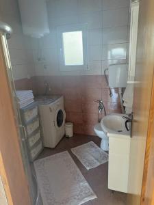 a bathroom with a sink and a washing machine at One floor of house in Bar