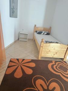 a bedroom with a bed and a rug on the floor at One floor of house in Bar