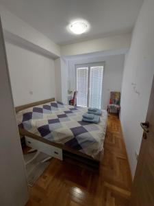 a bedroom with a large bed with a checkered floor at Enjoy Apartments Karamach in Ohrid