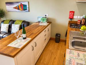a kitchen with a counter with wine glasses on it at Whitby Sea View Cottage Prime Historic Old Town Location in Whitby +30 photos