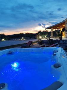 a blue bath tub with a sunset in the background at Holiday home Villa Juli in Šibenik