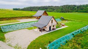 an overhead view of a house and a pool at Domek na Bieszczadach Domek na Bani 2 in Łukowe