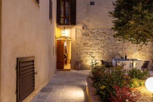an entrance to a building with a table and a door at Casa Costarella - San Gimignano in San Gimignano