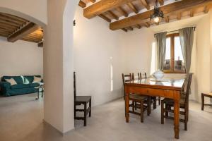 a dining room with a wooden table and chairs at Casa Costarella - San Gimignano in San Gimignano +16 photos