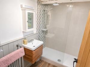 a bathroom with a sink and a shower at Whitby Sea View Cottage Prime Historic Old Town Location in Whitby