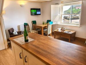 a living room with a table and a dining room at Whitby Sea View Cottage Prime Historic Old Town Location in Whitby