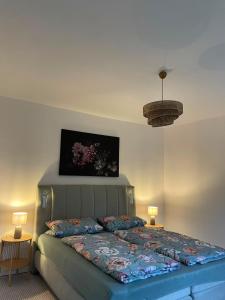 a bedroom with a bed with a painting on the wall at Landliebe in Blomberg