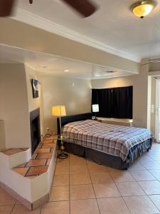 a large bedroom with a bed and a fireplace at CRYStALZ pool studio kitchen DWNtWN stadiums arts in Phoenix +22 photos