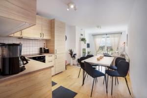 a kitchen and dining room with a table and chairs at "schön-urlauben" in Gröbming