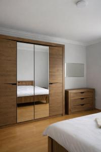 a bedroom with a large sliding glass closet at Woodside House in Solotvyno