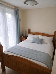 a bed in a bedroom with a large window at Chalet 85 in Caeathro