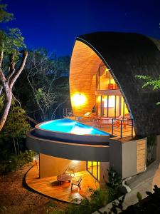 a circular house with a swimming pool at night at Villa Green Diamond in Playa Flamingo