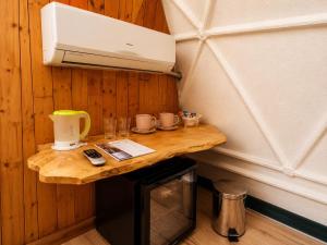 a small table in a room with a coffee machine at Soho-place in Bran
